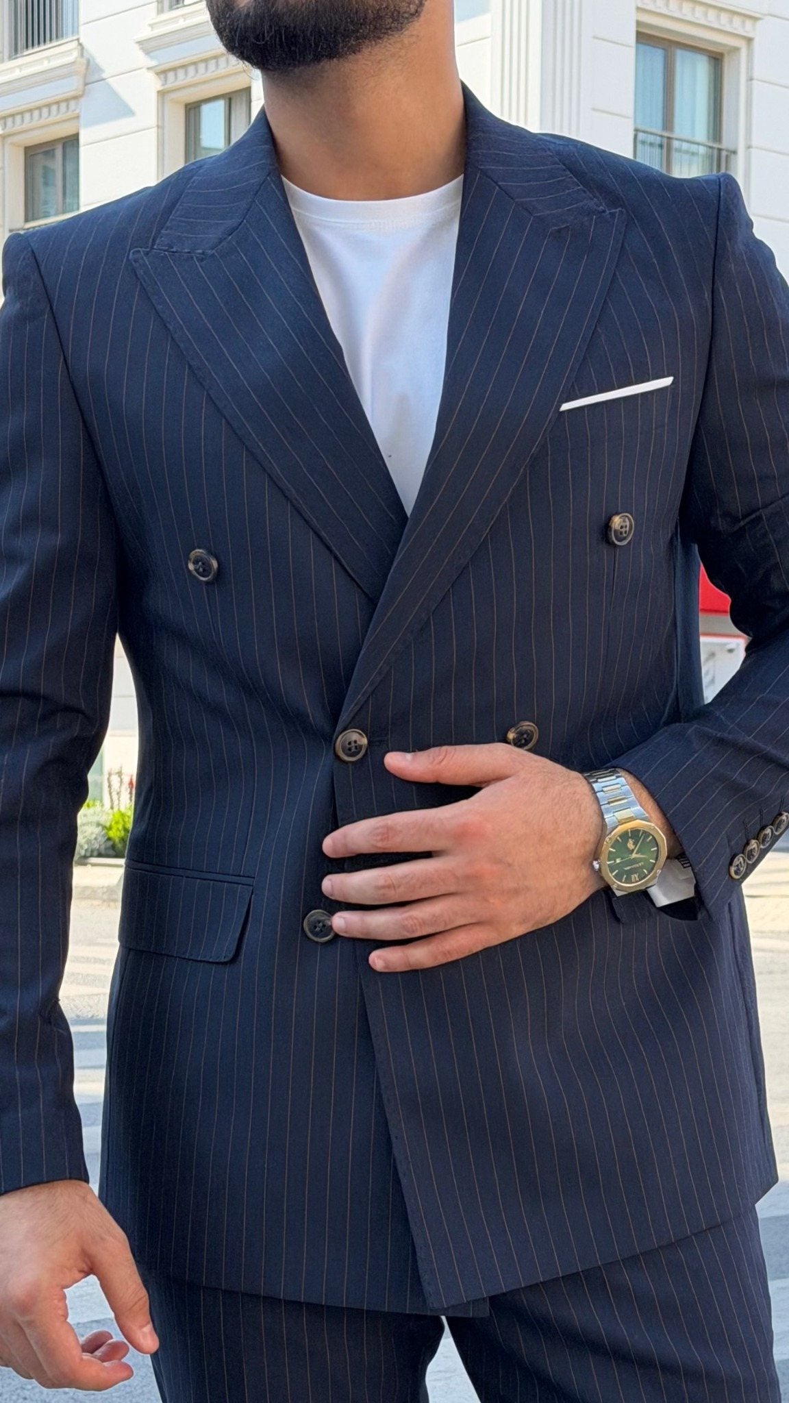Close front detail of navy blue pinstripe double-breasted suit jacket