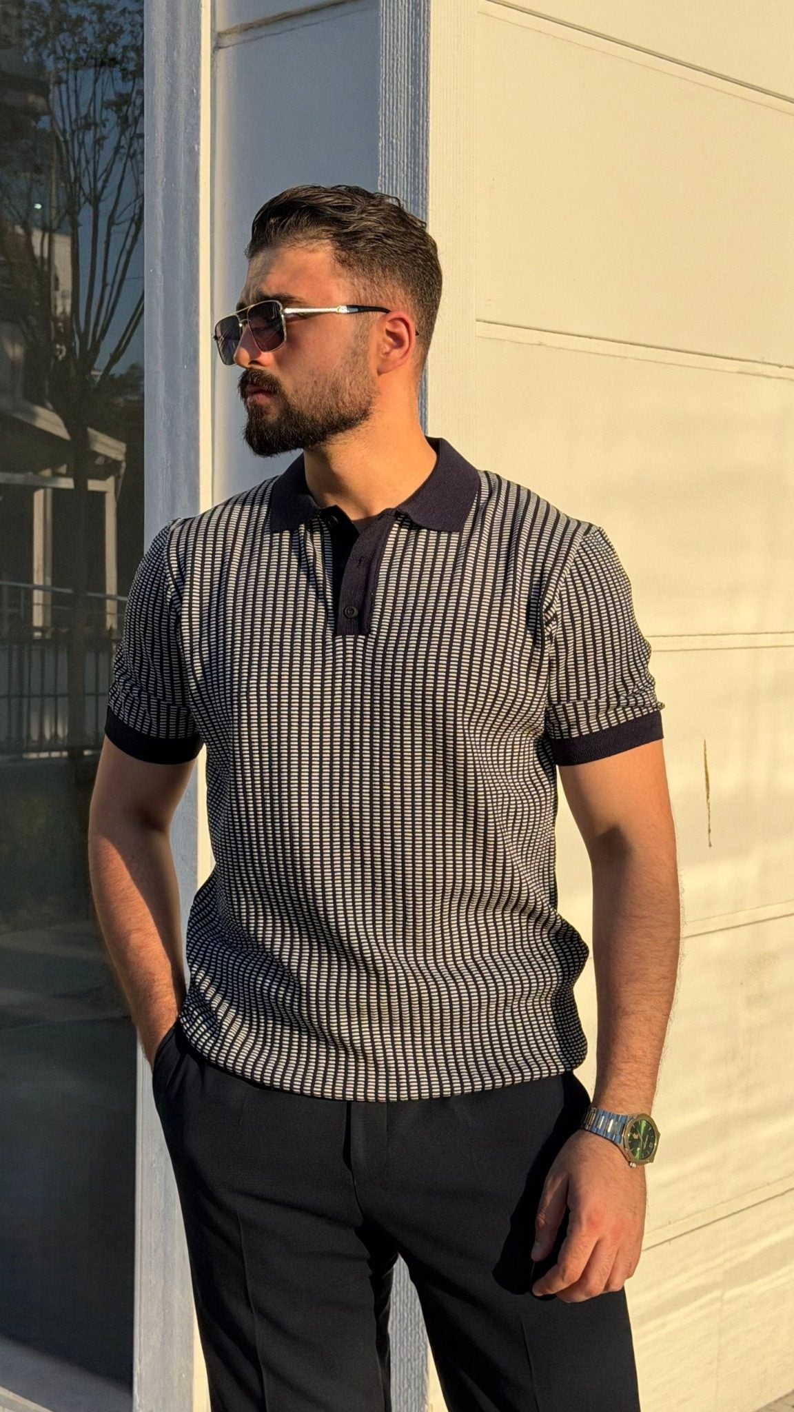 Front view of men's navy blue textured knit short-sleeve polo shirt