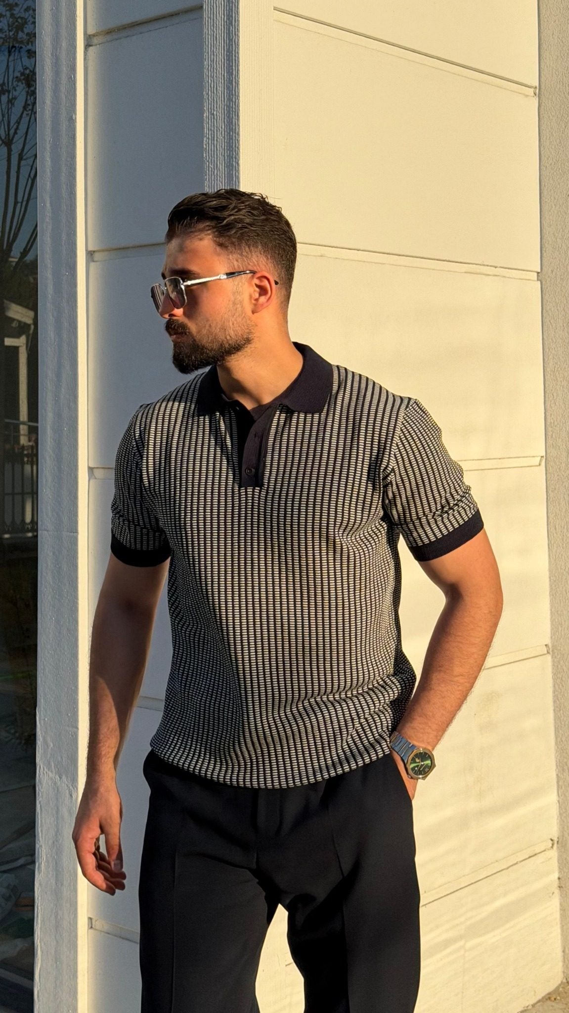 Men's navy blue textured knit polo shirt in a smart casual outdoor look