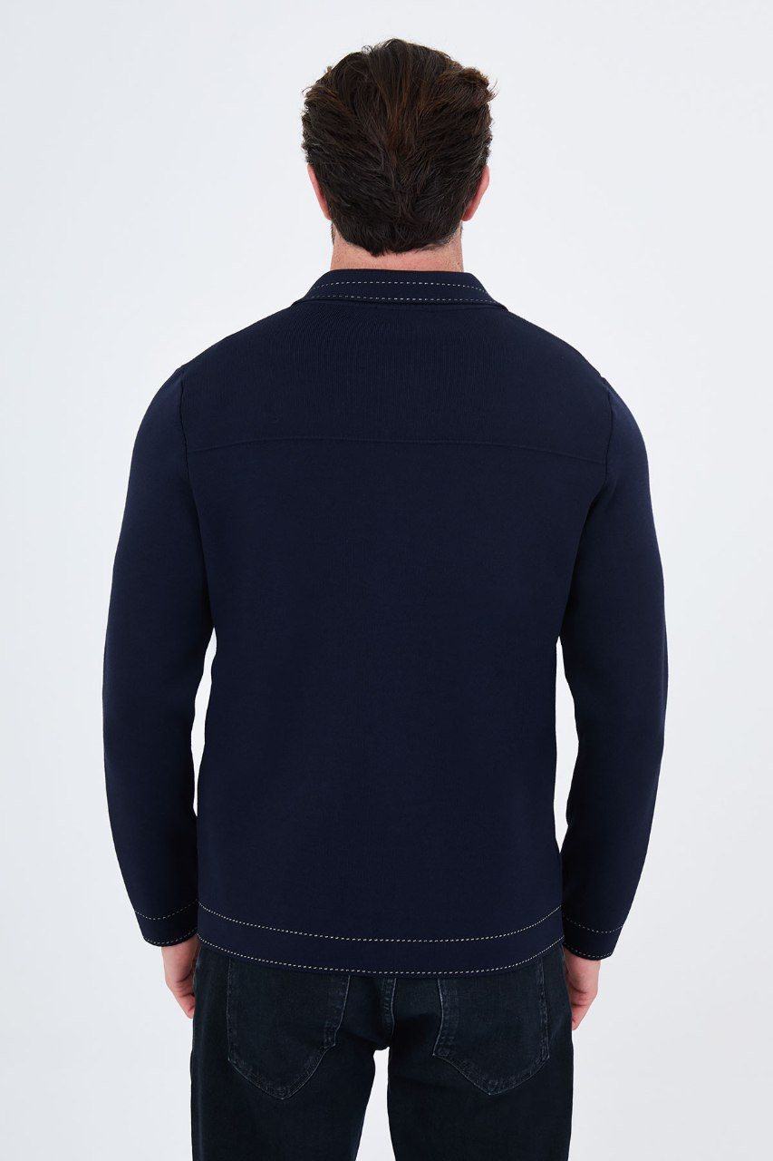 Man wearing a navy button-front cardigan with contrast trim, back view