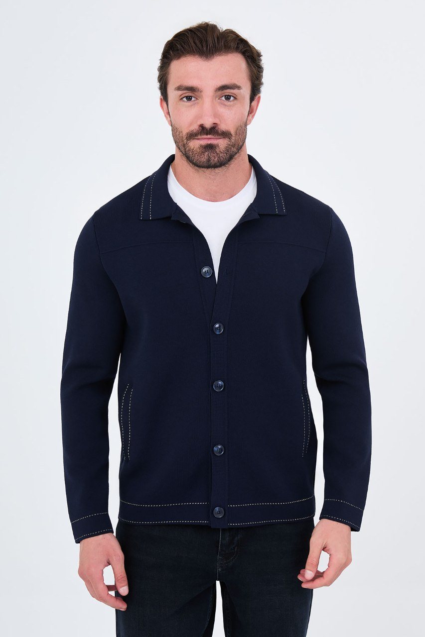Man wearing a navy button-front cardigan with contrast trim, front view