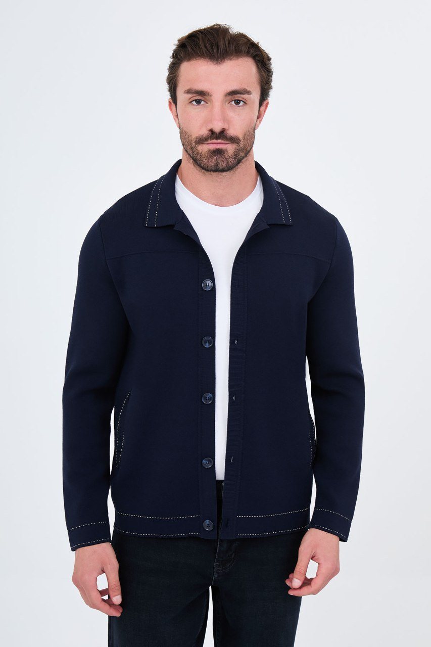 Man wearing a navy button-front cardigan with contrast trim, open front view