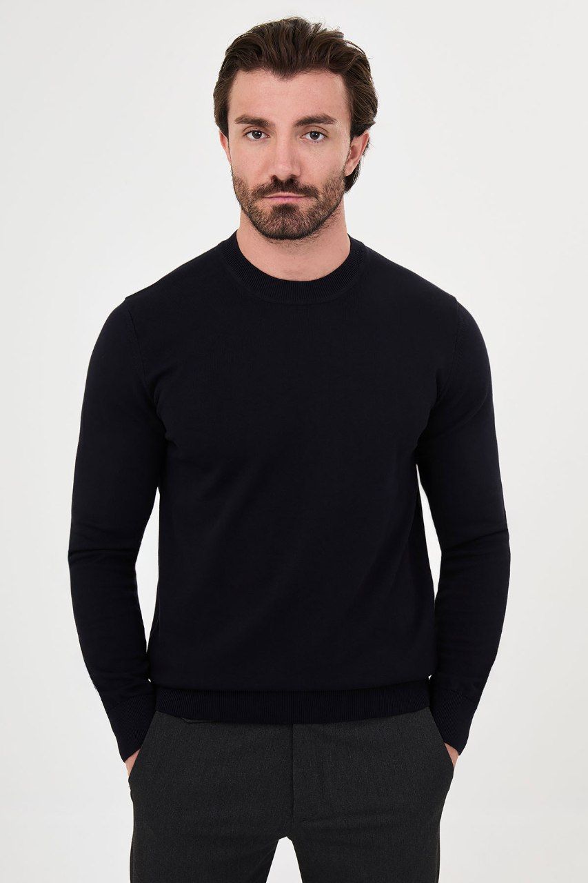 Front view of a man wearing a navy crew neck sweater with long sleeves