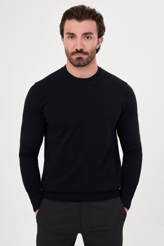 Front view of a man wearing a navy crew neck sweater with long sleeves