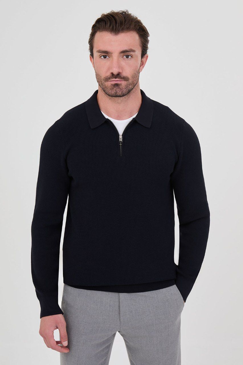 Front view of a man wearing a navy ribbed quarter-zip polo sweater