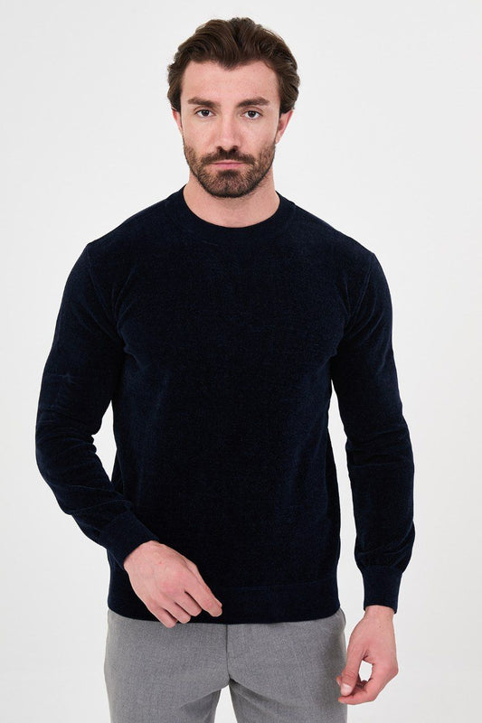 Front view of a man wearing a navy textured crew-neck sweater