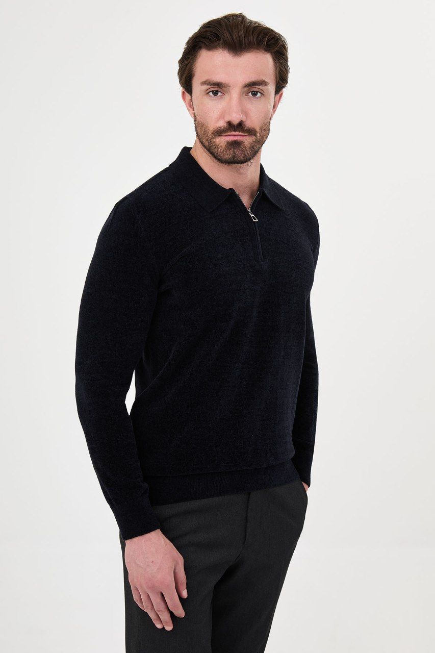 Angled view of a man wearing a navy textured quarter-zip polo sweater
