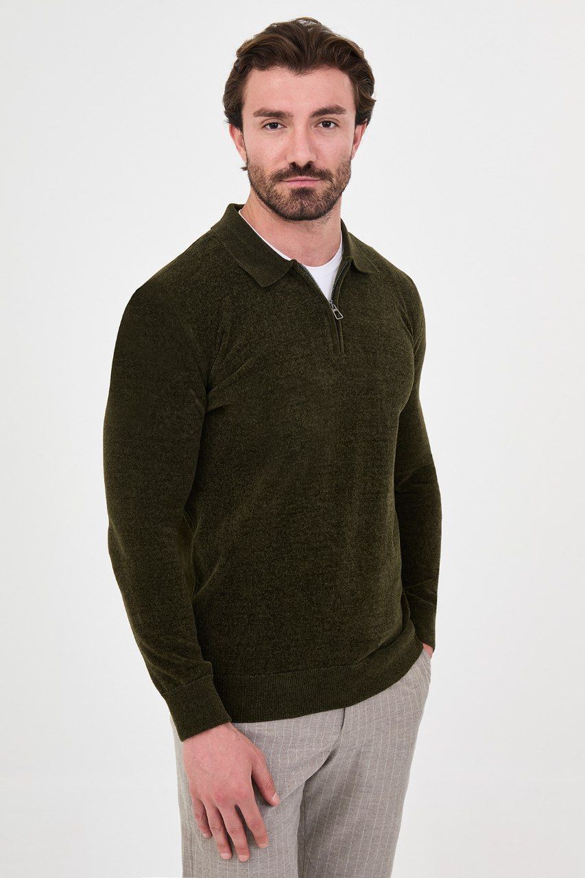 Angled view of a man wearing a olive textured quarter-zip polo sweater
