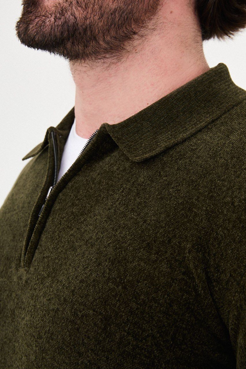 Close-up of the olive sweater's textured knit, polo collar and quarter-zip fastening