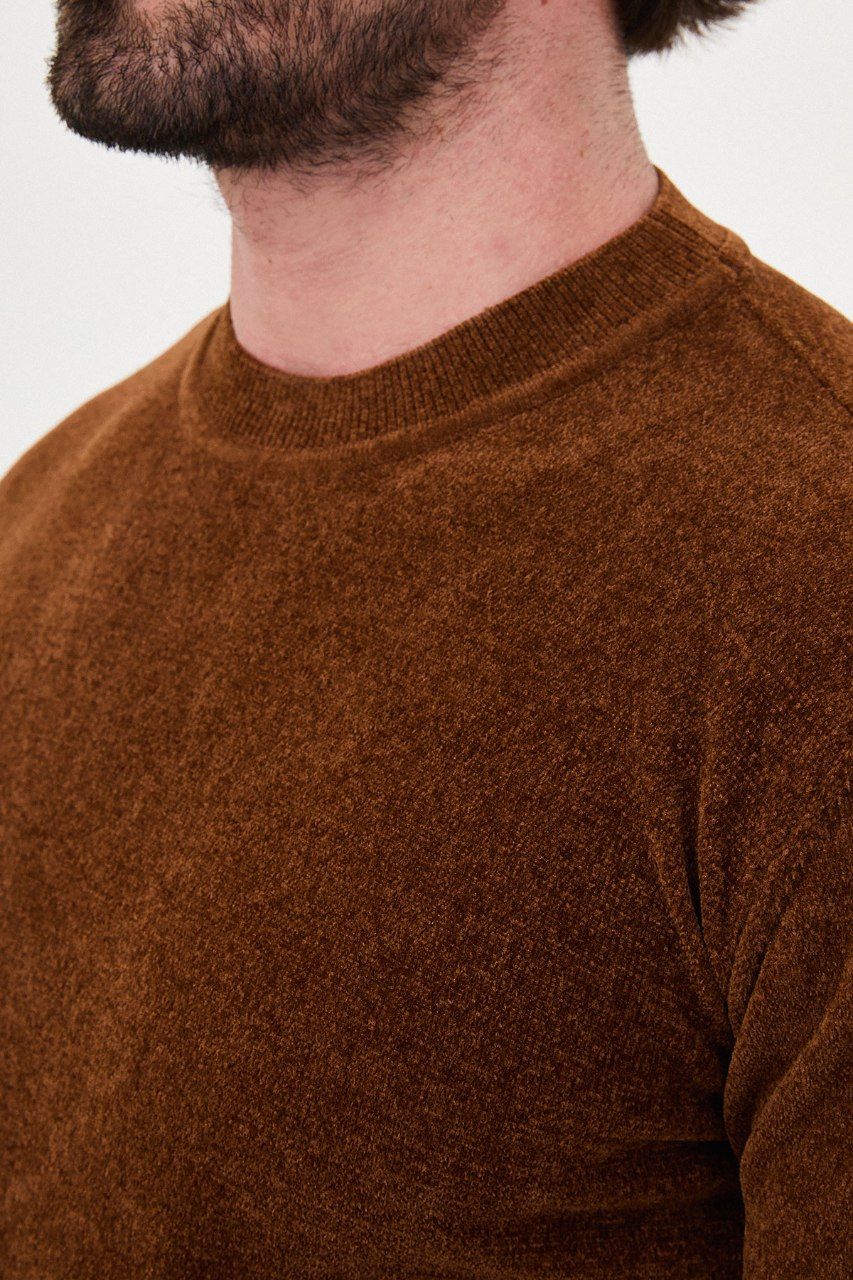 Close-up of the rust sweater's textured knit and crew neckline