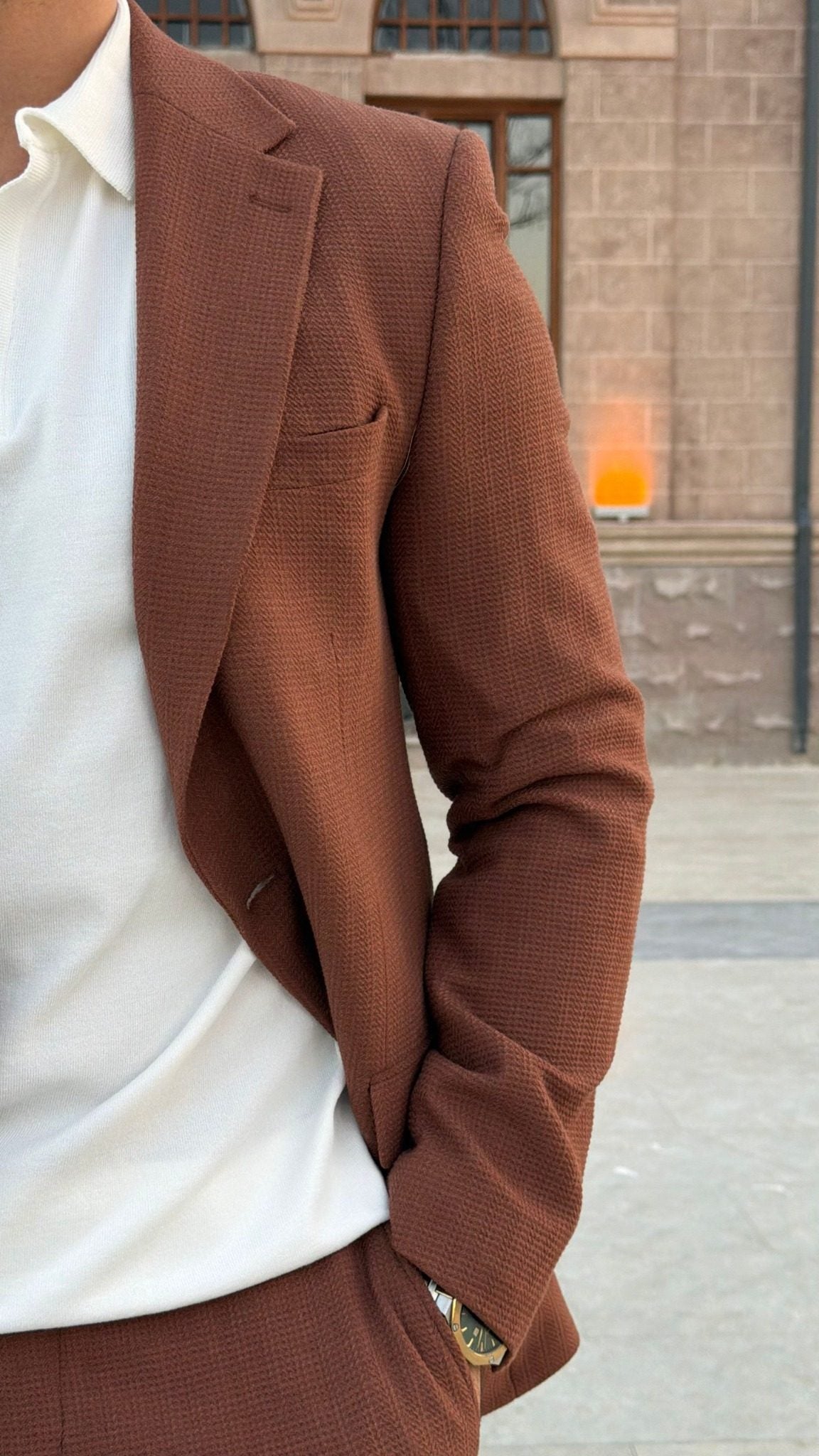 Side detail of men's Tile textured suit jacket with notch lapel and chest welt pocket
