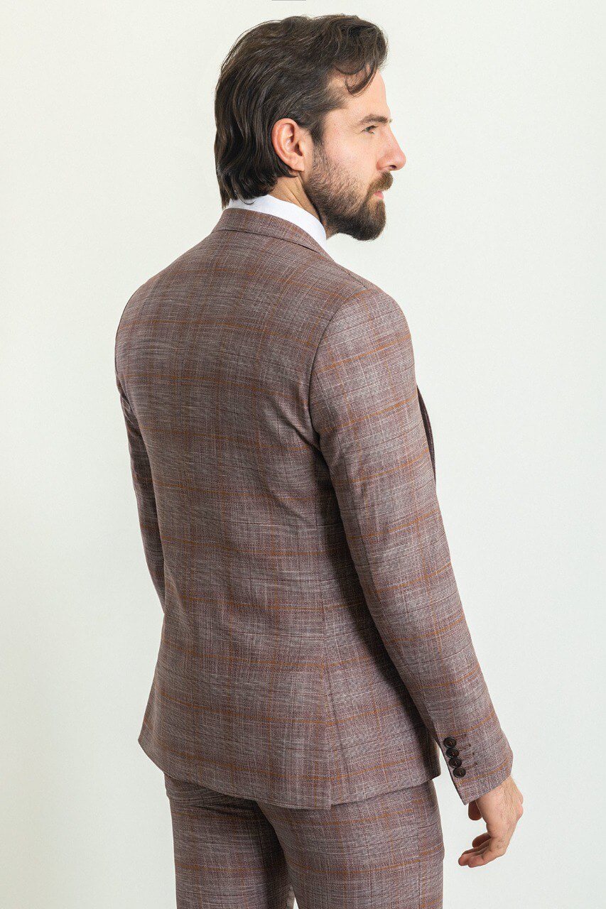 Man wearing a stylish patterned burgundy suit with a red tie and pocket square, showcasing elegant men's formal wear from Suitharbor.