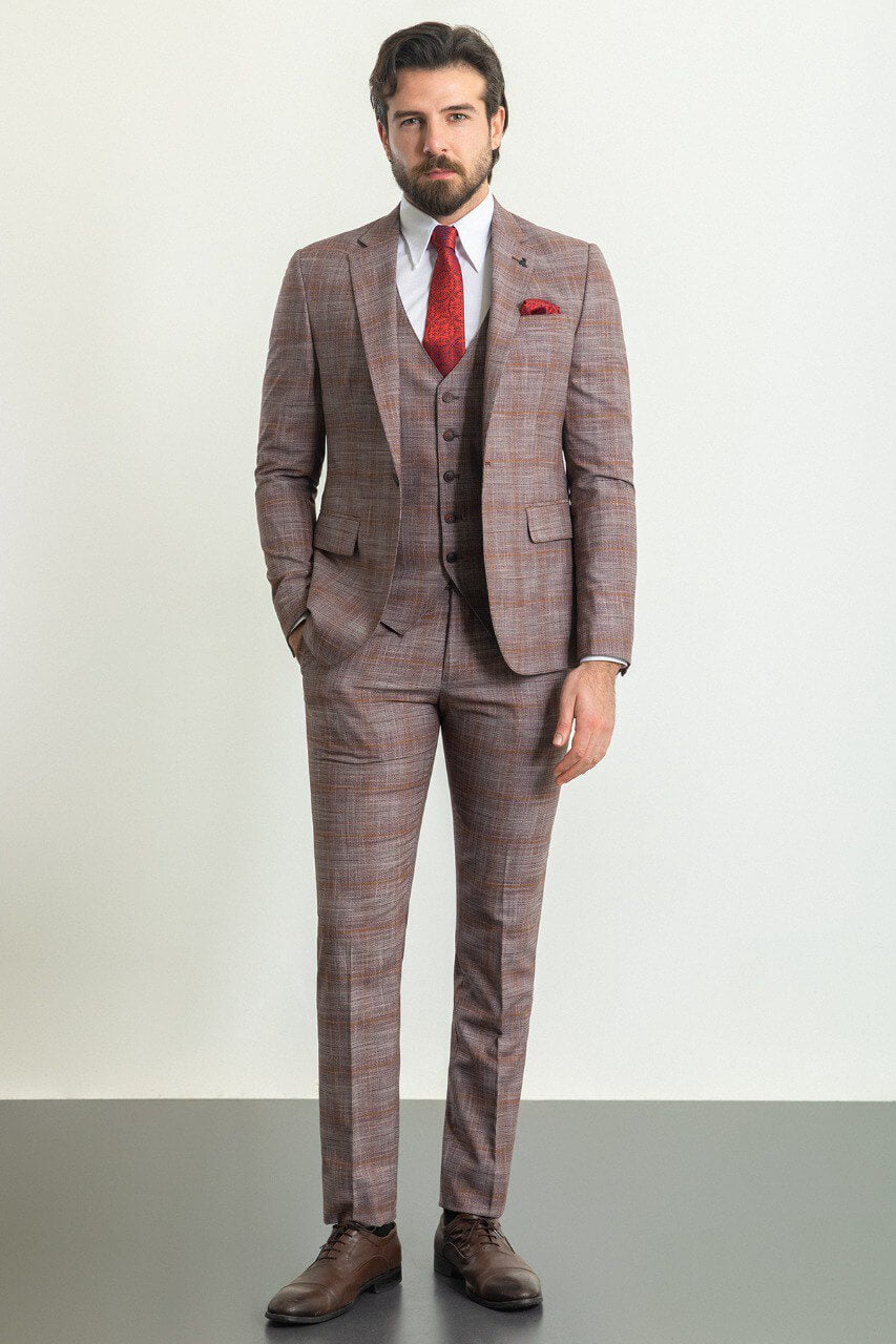 Man wearing a stylish patterned burgundy suit with a red tie and pocket square, showcasing elegant men's formal wear from Suitharbor.