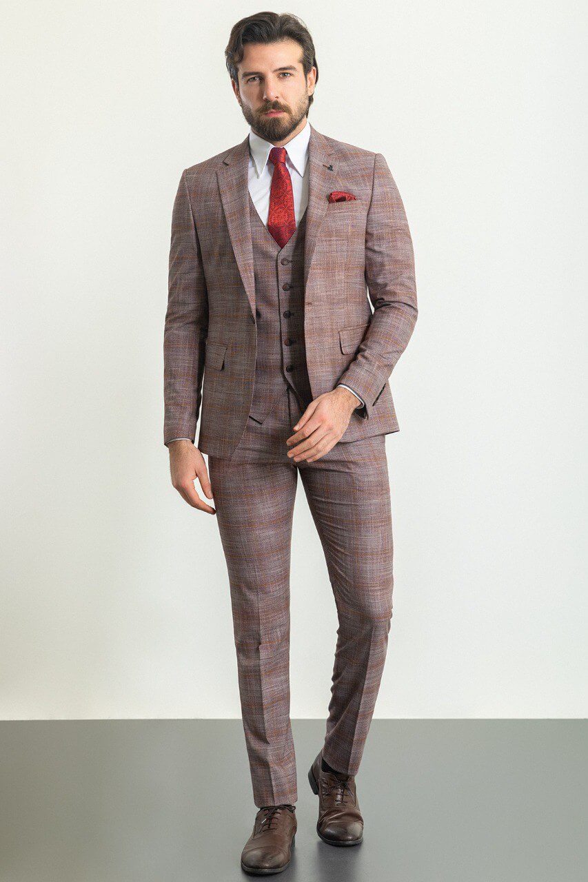 Man wearing a stylish patterned burgundy suit with a red tie and pocket square, showcasing elegant men's formal wear from Suitharbor.