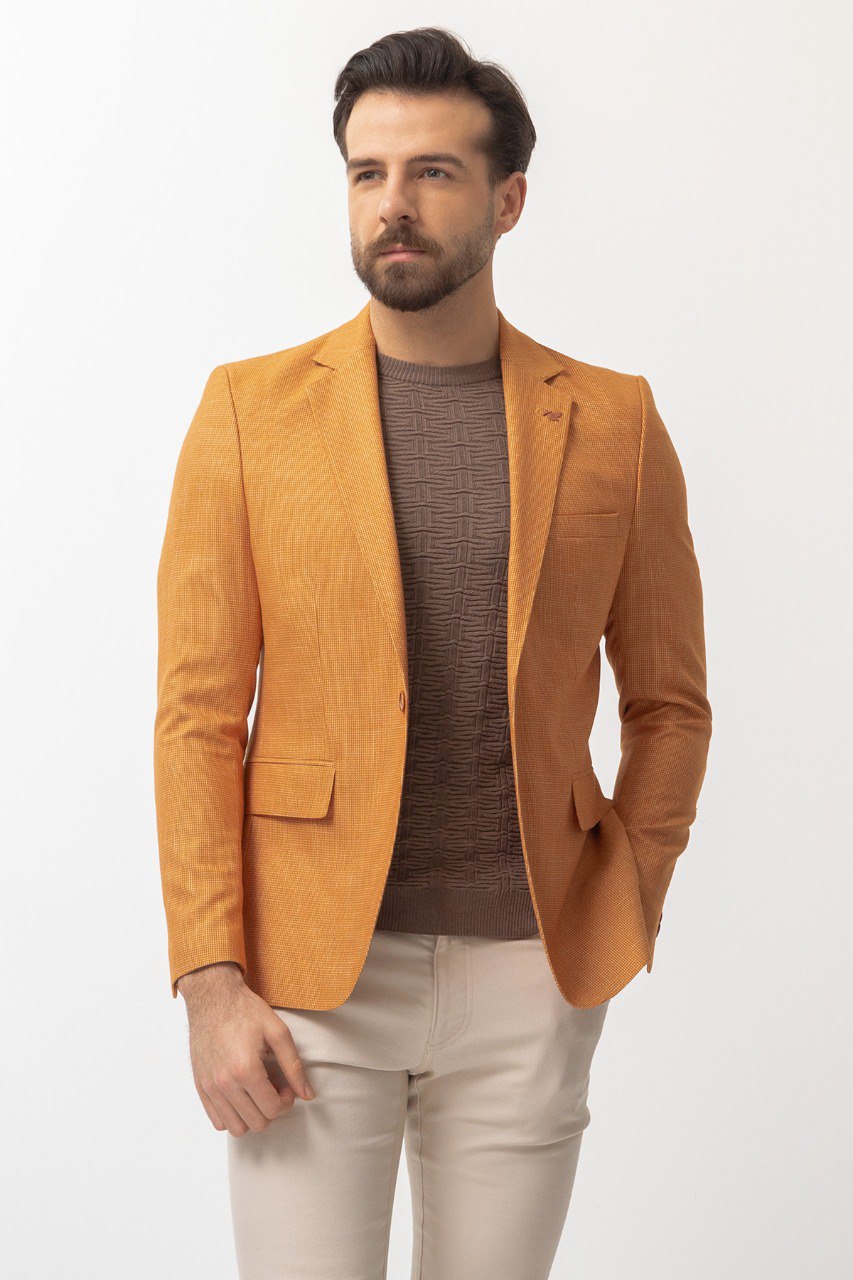 Man wearing a Golden Hour Blazer with a pointed collar, flap pockets, and a slim fit, perfect for summer weddings and casual outings.