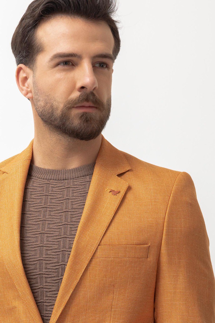 Man wearing a Golden Hour Blazer with a pointed collar, flap pockets, and a slim fit, perfect for summer weddings and casual outings.