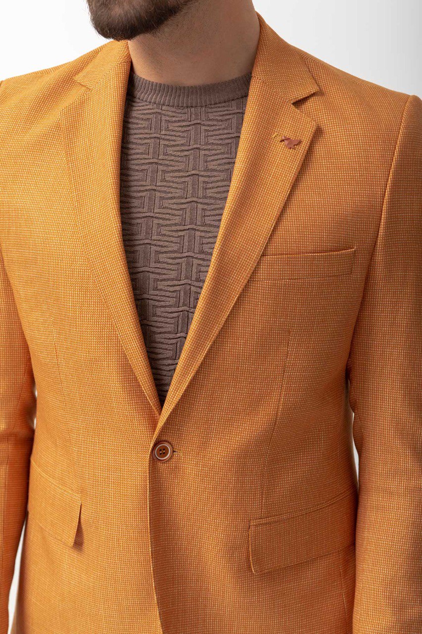 Man wearing a Golden Hour Blazer with a pointed collar, flap pockets, and a slim fit, perfect for summer weddings and casual outings.