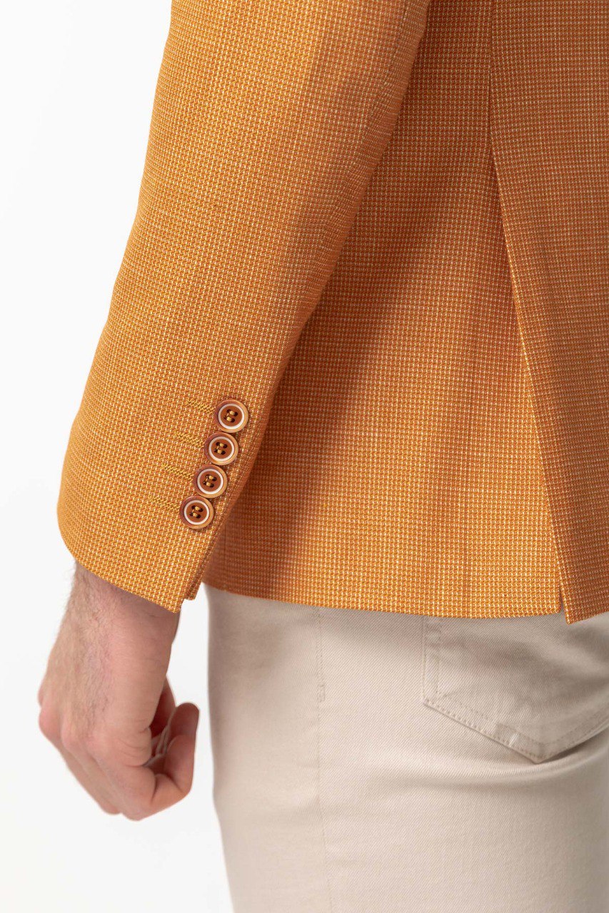 Man wearing a Golden Hour Blazer with a pointed collar, flap pockets, and a slim fit, perfect for summer weddings and casual outings.