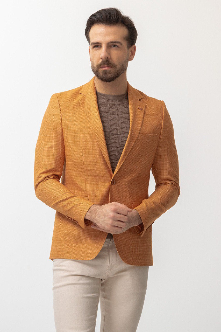 Man wearing a Golden Hour Blazer with a pointed collar, flap pockets, and a slim fit, perfect for summer weddings and casual outings.