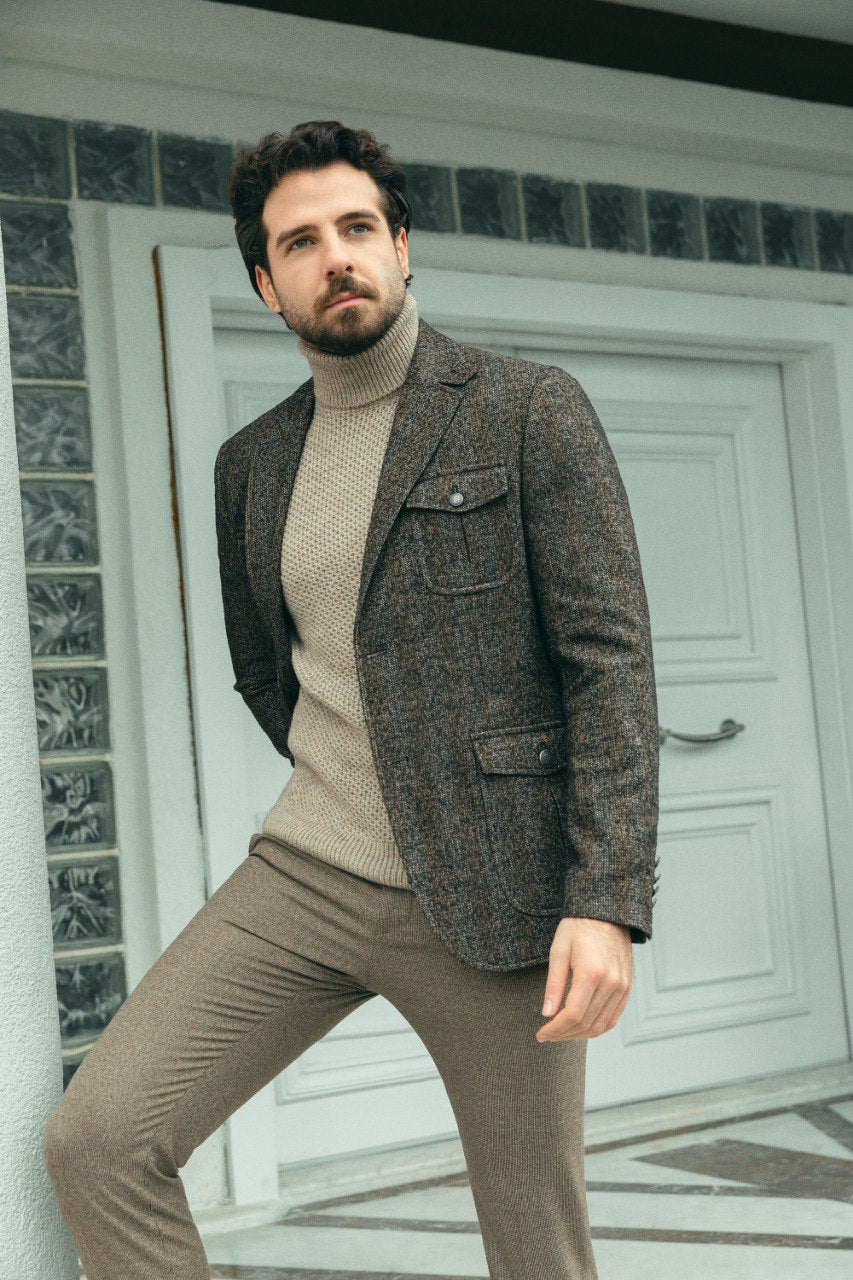 Man wearing a Chestnut Tweed Blazer with a pointed collar, flap pockets, and a slim fit, perfect for autumn gatherings and business meetings.