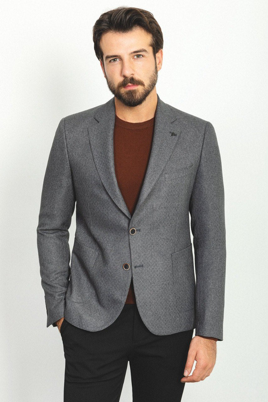 Man wearing an Urban Steel Blazer with a pointed collar, flap pockets, and a slim fit, perfect for business meetings and weddings.