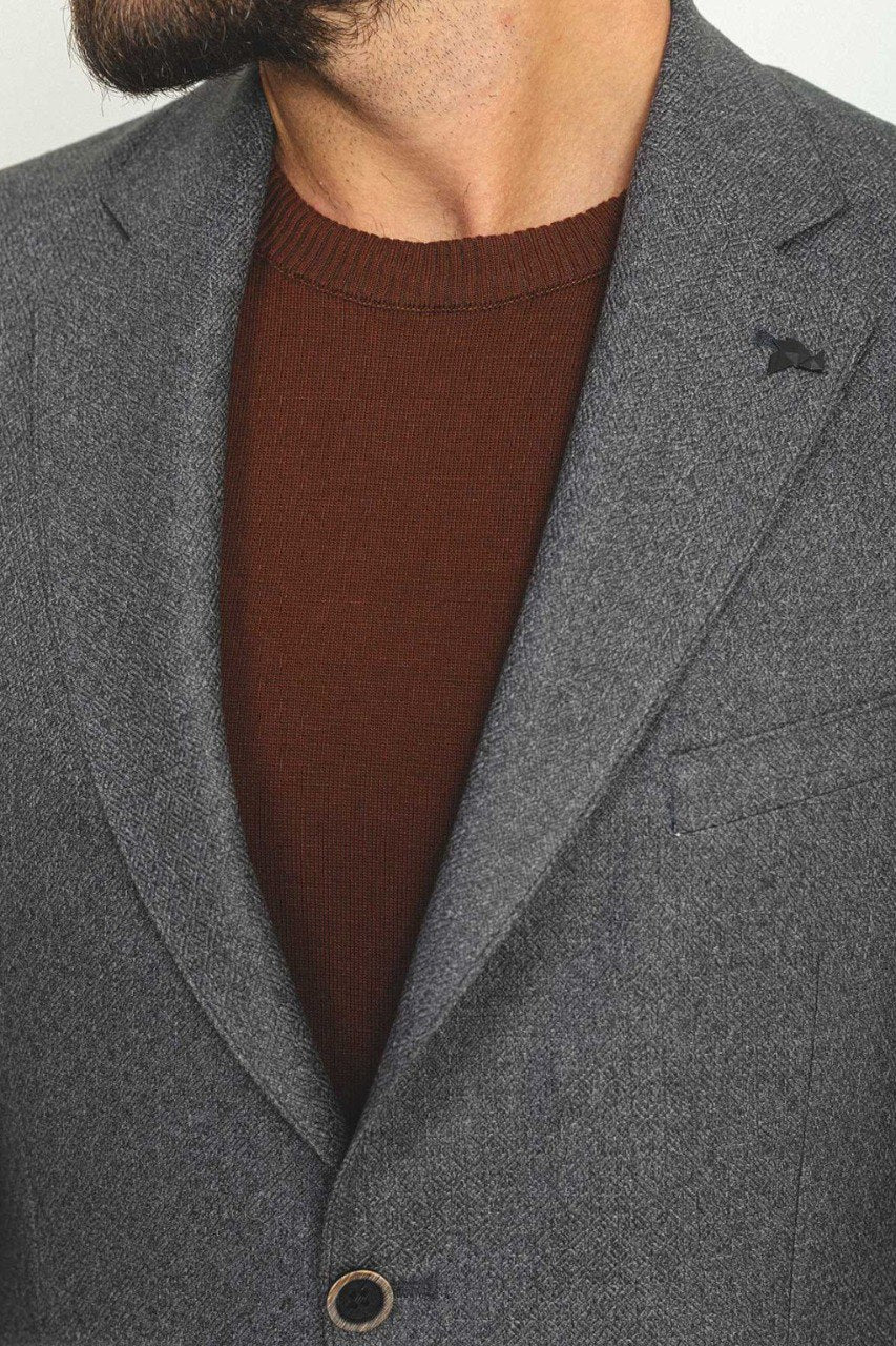 Man wearing an Urban Steel Blazer with a pointed collar, flap pockets, and a slim fit, perfect for business meetings and weddings.