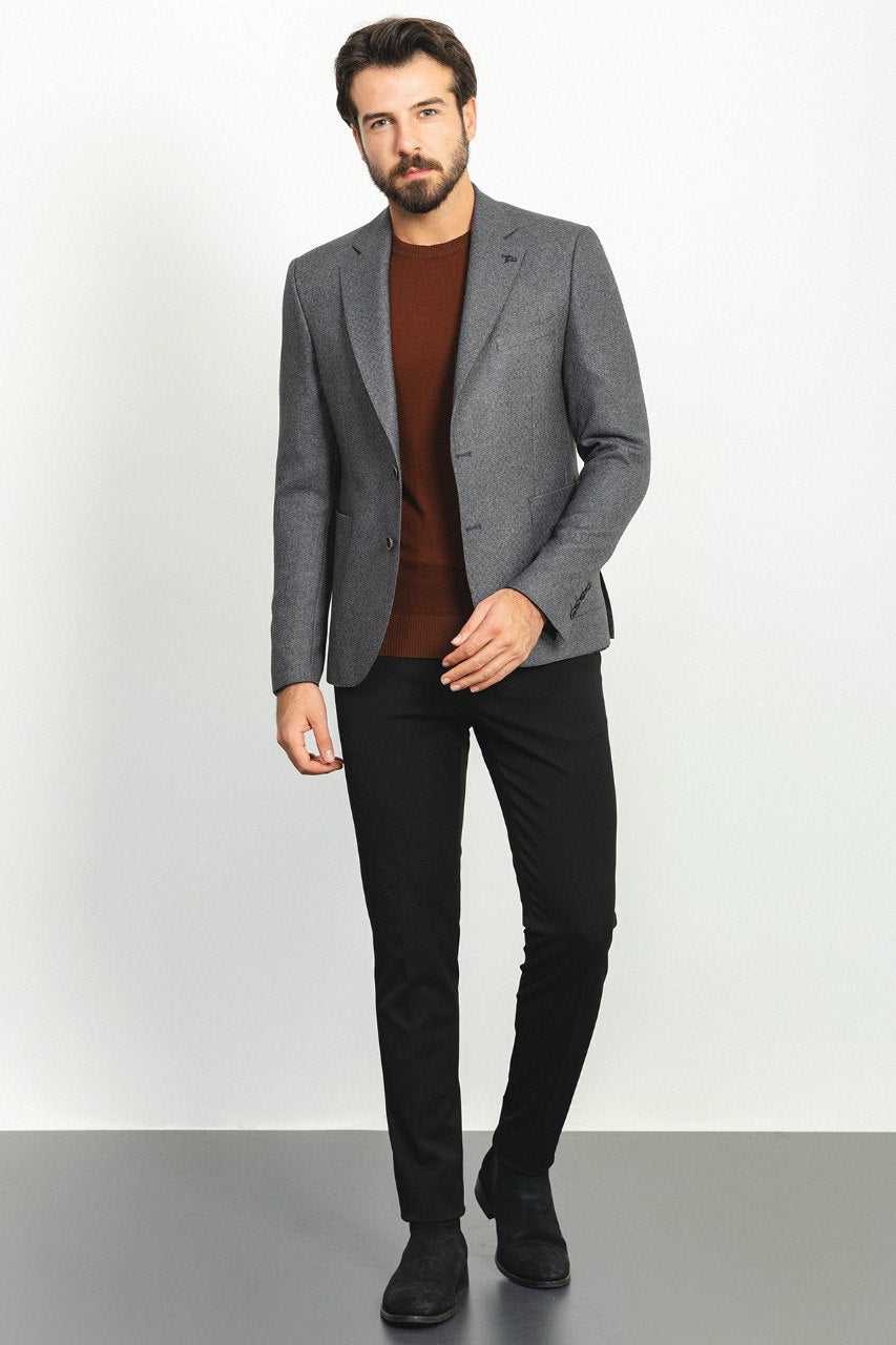 Man wearing an Urban Steel Blazer with a pointed collar, flap pockets, and a slim fit, perfect for business meetings and weddings.