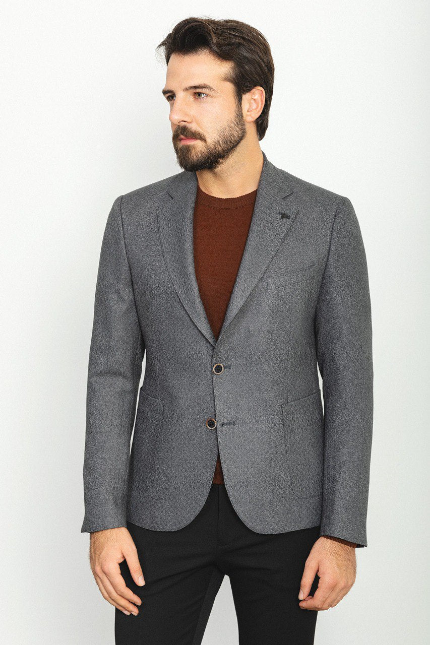 Man wearing an Urban Steel Blazer with a pointed collar, flap pockets, and a slim fit, perfect for business meetings and weddings.