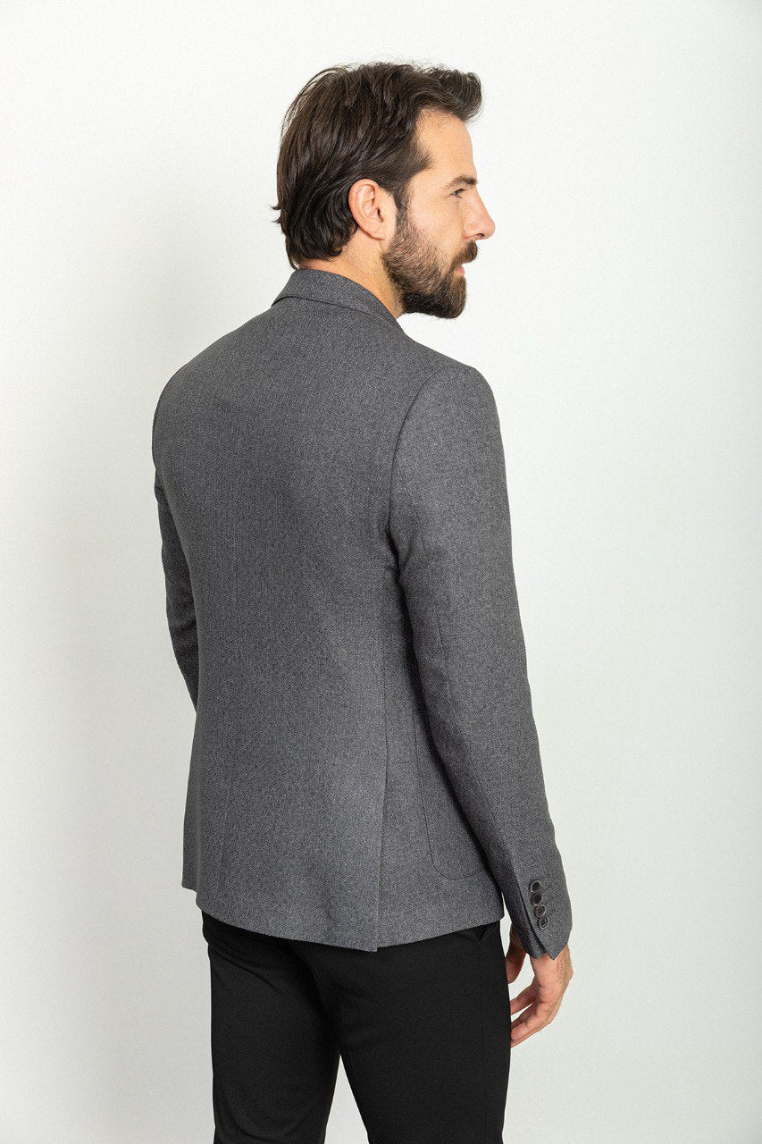 Man wearing an Urban Steel Blazer with a pointed collar, flap pockets, and a slim fit, perfect for business meetings and weddings.