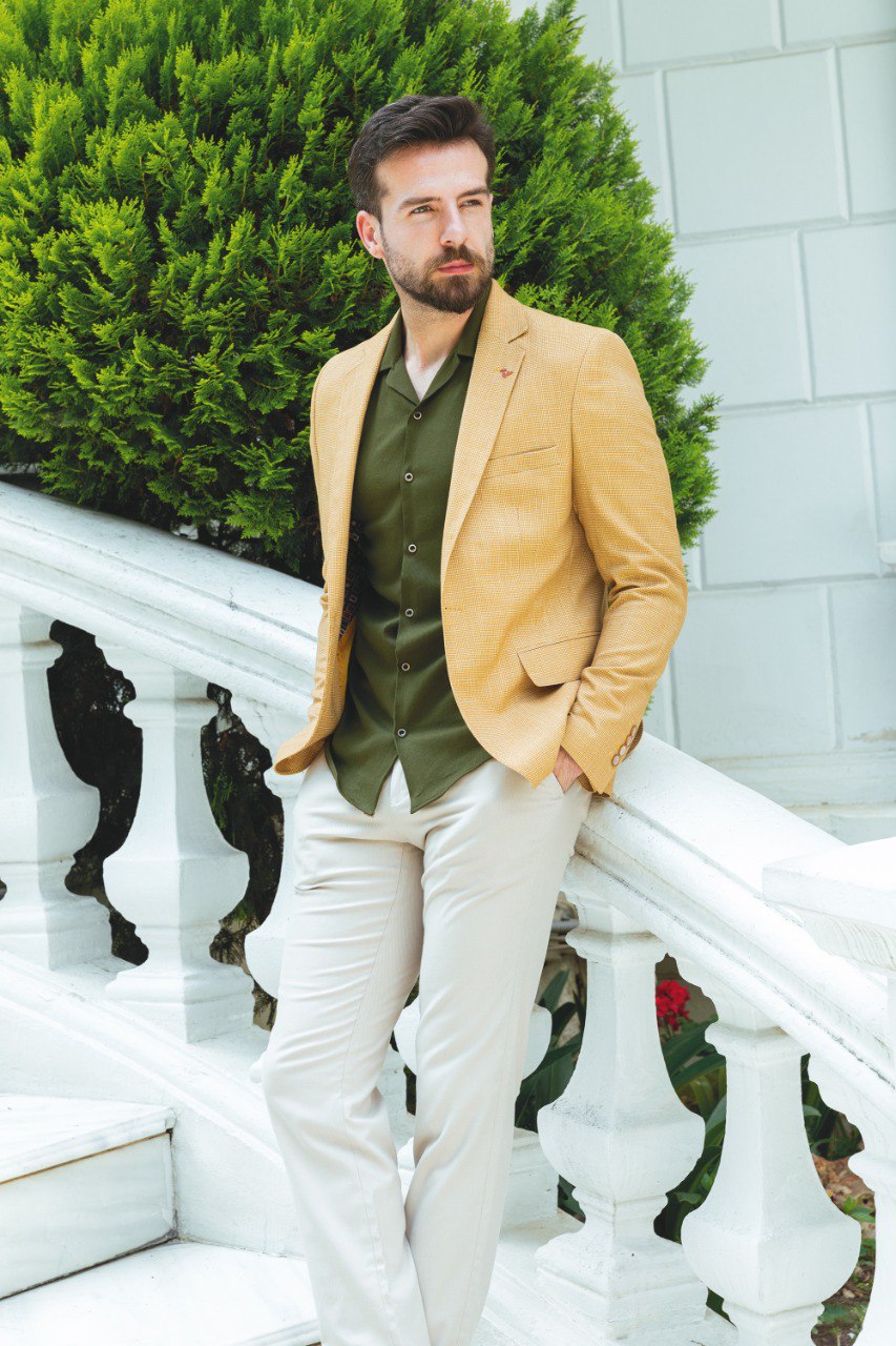 Man wearing a Sunlit Meadow Blazer with a pointed collar, flap pockets, and a slim fit, perfect for summer weddings and casual outings.