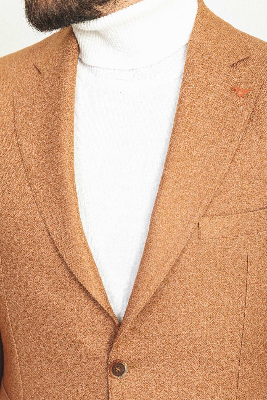 Man wearing a Camel Sophistication Blazer with a pointed collar, flap pockets, and a slim fit, perfect for weddings and business meetings.