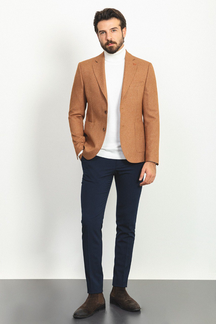 Man wearing a Camel Sophistication Blazer with a pointed collar, flap pockets, and a slim fit, perfect for weddings and business meetings.