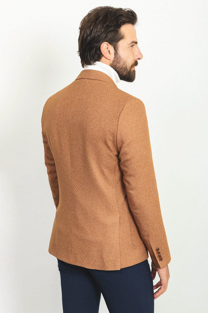 Man wearing a Camel Sophistication Blazer with a pointed collar, flap pockets, and a slim fit, perfect for weddings and business meetings.