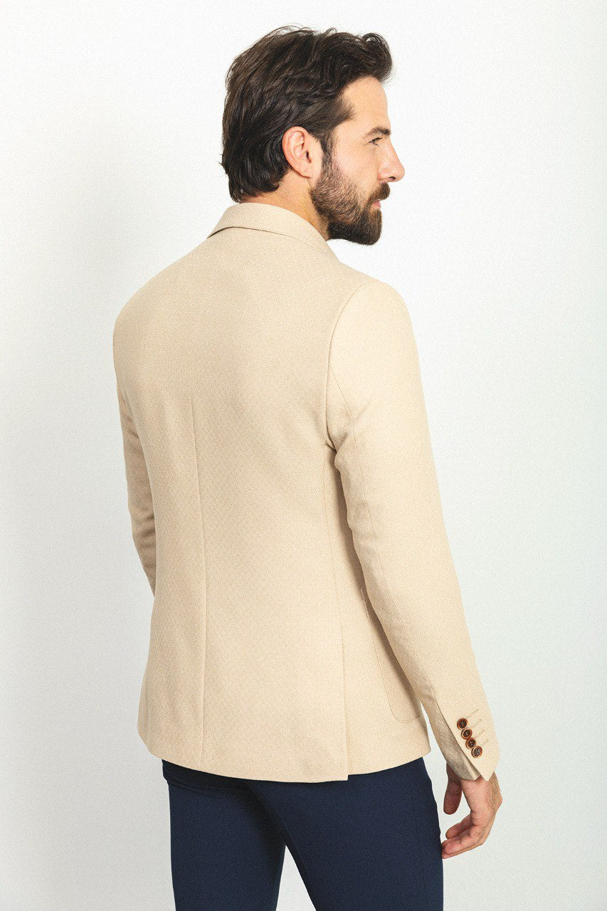 Man wearing a Sandstone Elegance Blazer with a pointed collar, flap pockets, and a slim fit, perfect for weddings and business meetings.