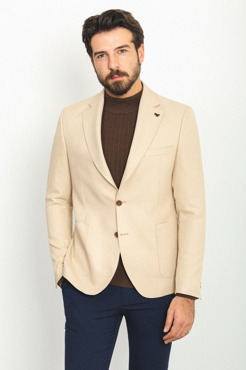 Man wearing a Sandstone Elegance Blazer with a pointed collar, flap pockets, and a slim fit, perfect for weddings and business meetings.