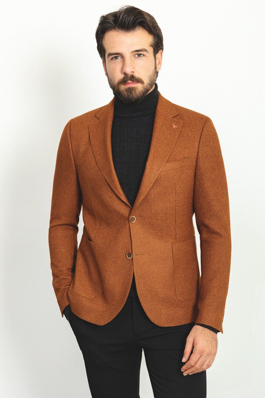 Man wearing a Hazelnut Heritage Blazer with a pointed collar, flap pockets, and a slim fit, perfect for formal events and casual outings.