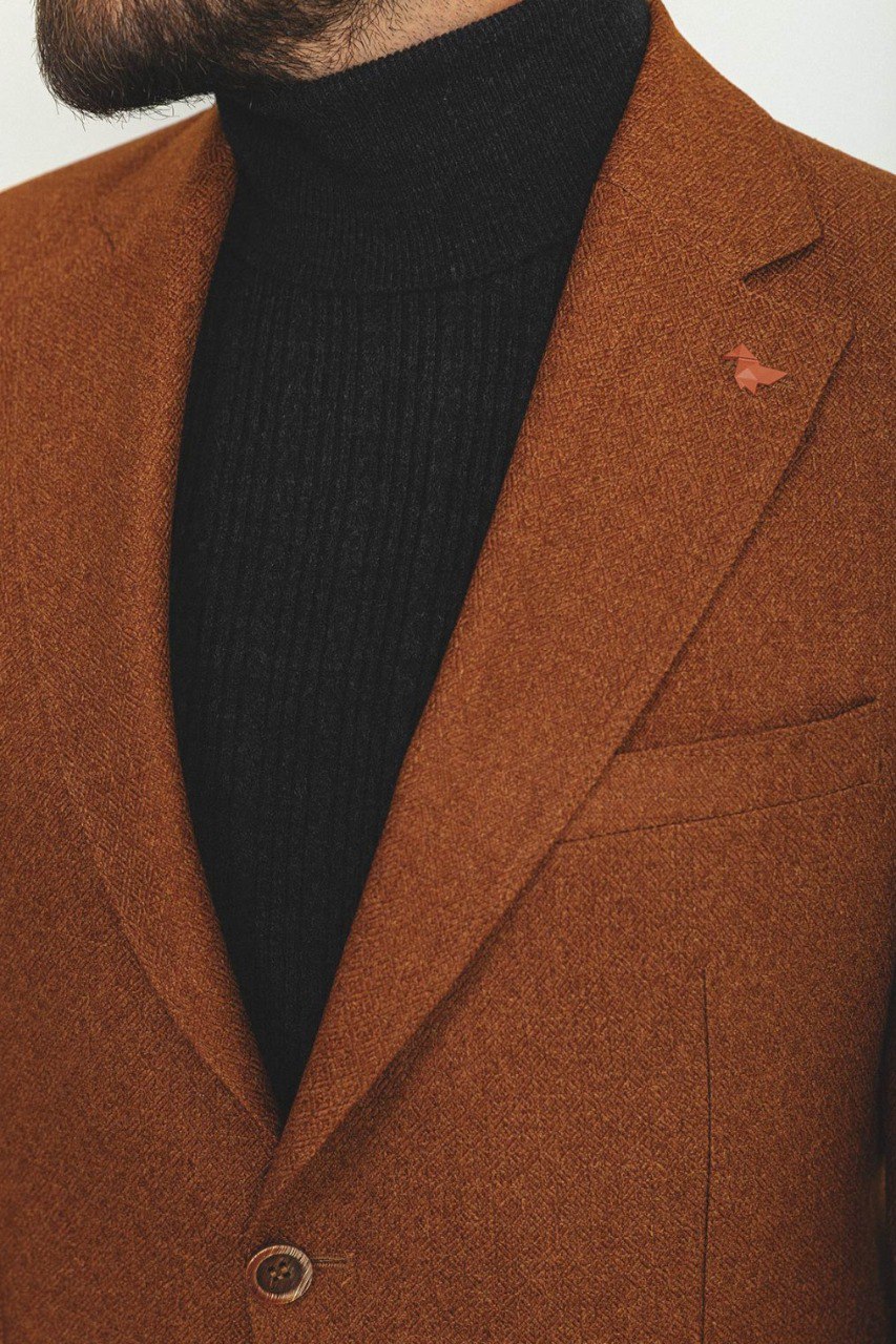 Man wearing a Hazelnut Heritage Blazer with a pointed collar, flap pockets, and a slim fit, perfect for formal events and casual outings.