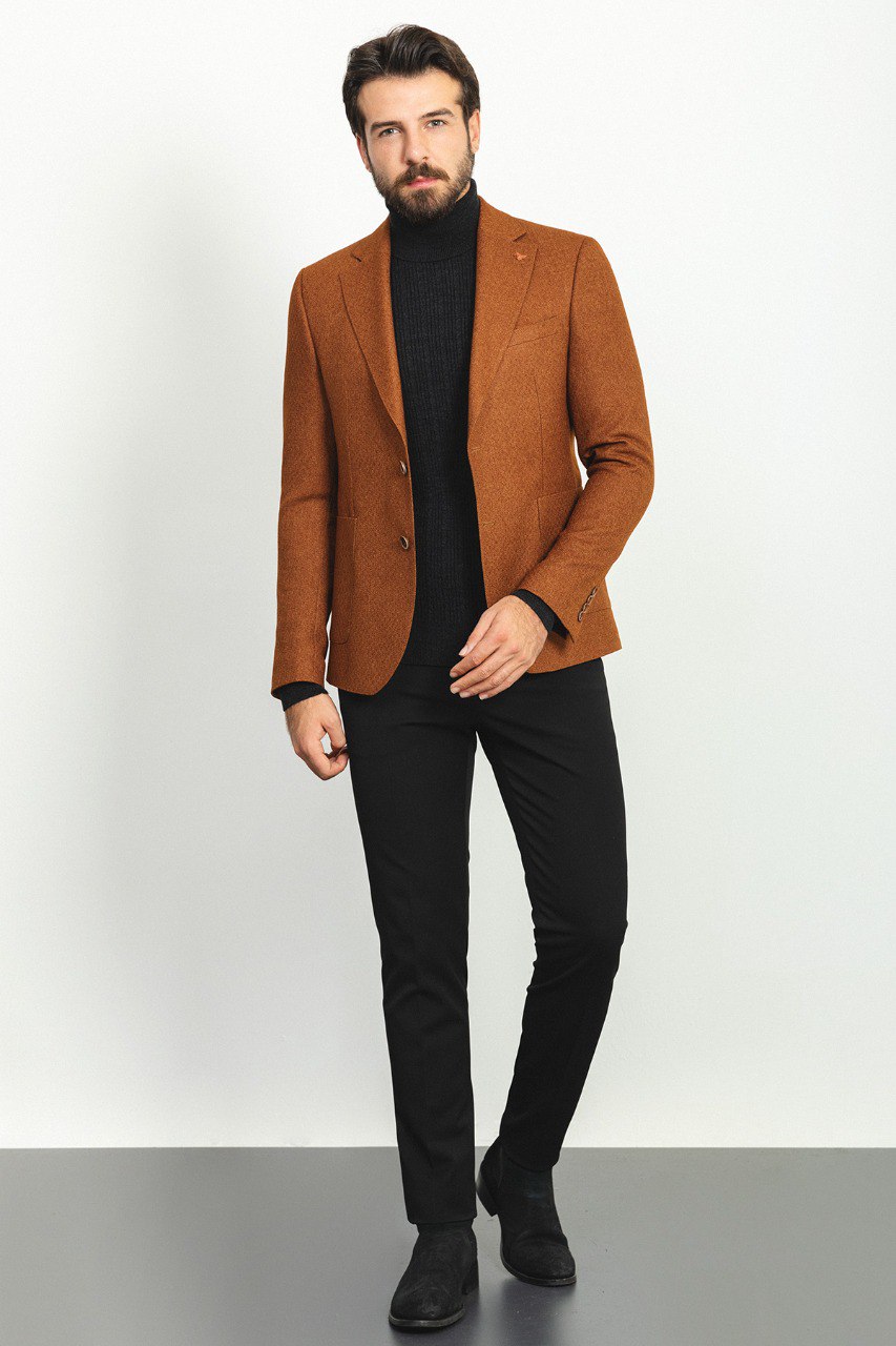 Man wearing a Hazelnut Heritage Blazer with a pointed collar, flap pockets, and a slim fit, perfect for formal events and casual outings.