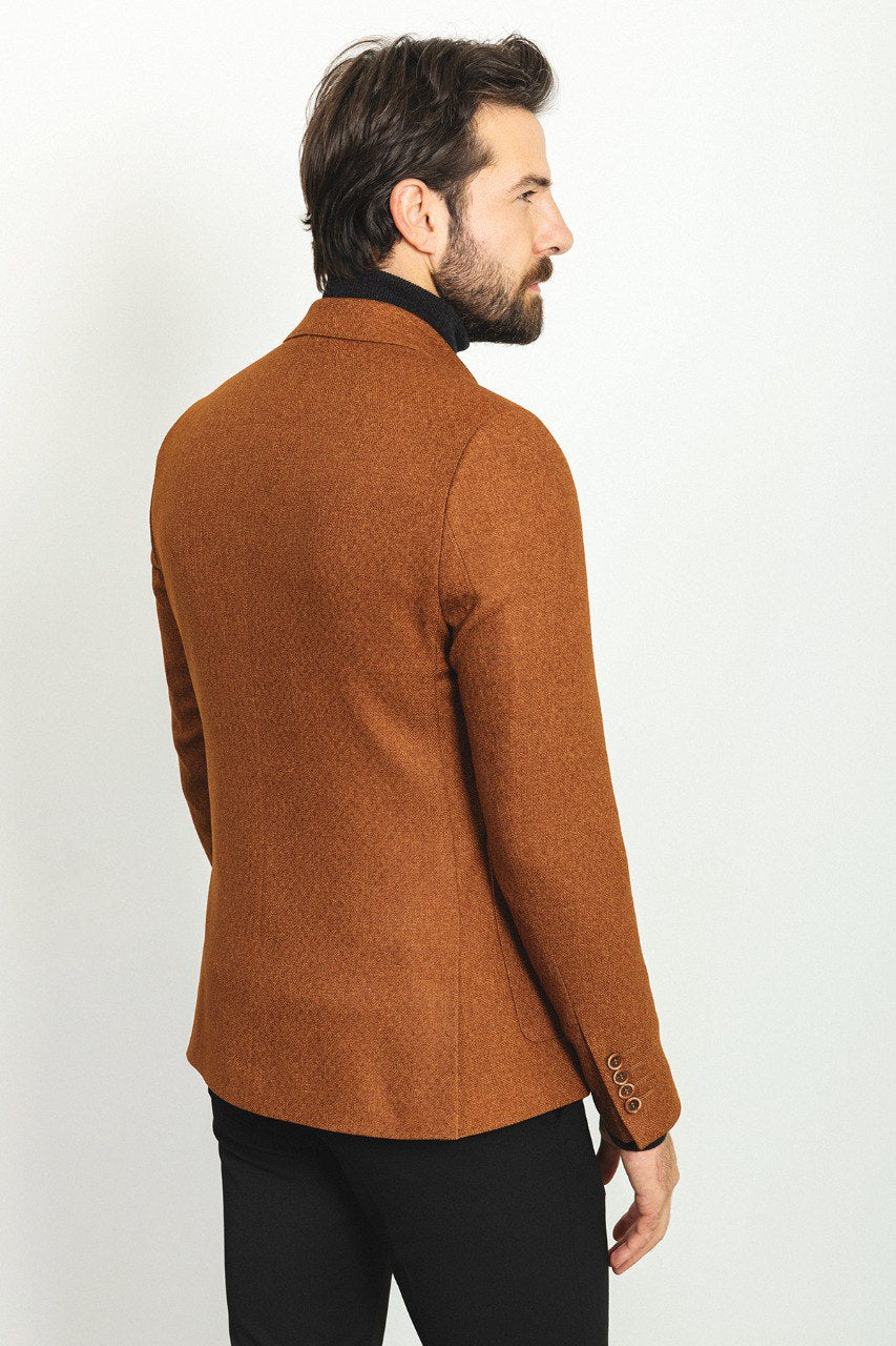 Man wearing a Hazelnut Heritage Blazer with a pointed collar, flap pockets, and a slim fit, perfect for formal events and casual outings.