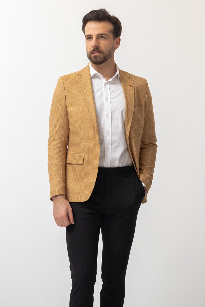 Man wearing a Sunlit Meadow Blazer with a pointed collar, flap pockets, and a slim fit, perfect for summer weddings and casual outings.