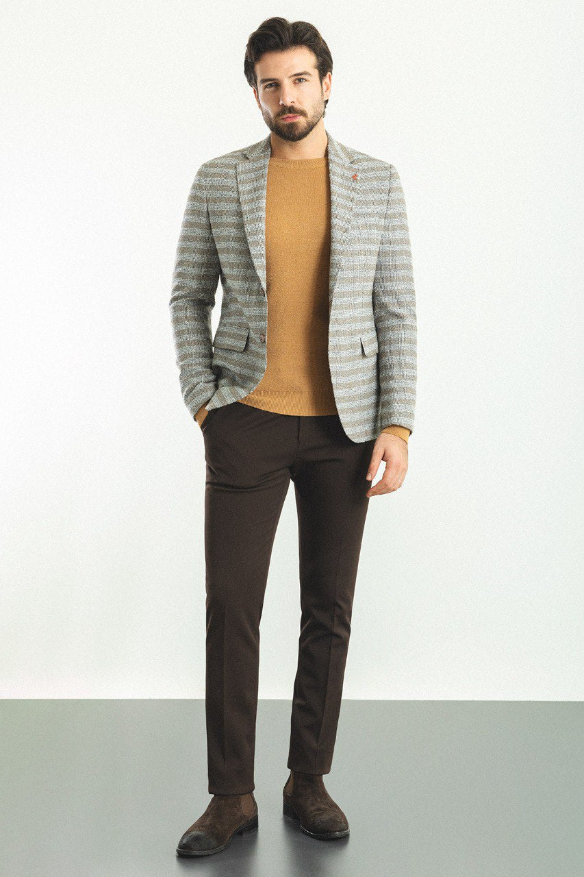 Man wearing an Autumn Glen Plaid Blazer with a pointed collar, flap pockets, and a slim fit, perfect for fall gatherings and business meetings.