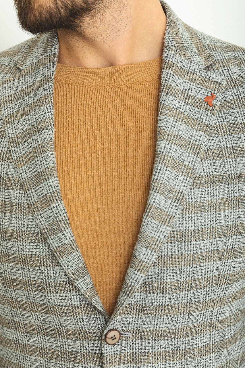 Man wearing an Autumn Glen Plaid Blazer with a pointed collar, flap pockets, and a slim fit, perfect for fall gatherings and business meetings.