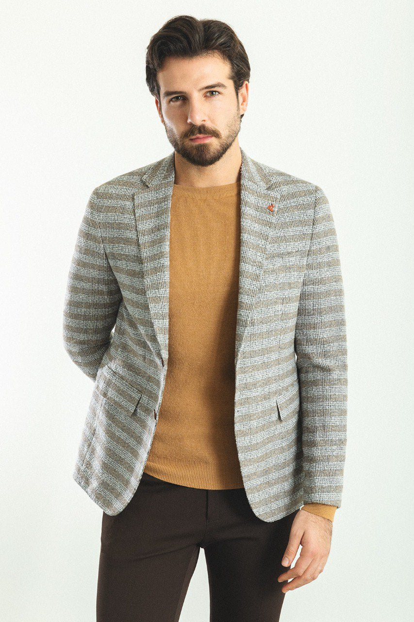 Man wearing an Autumn Glen Plaid Blazer with a pointed collar, flap pockets, and a slim fit, perfect for fall gatherings and business meetings.