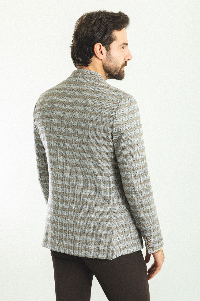 Man wearing an Autumn Glen Plaid Blazer with a pointed collar, flap pockets, and a slim fit, perfect for fall gatherings and business meetings.