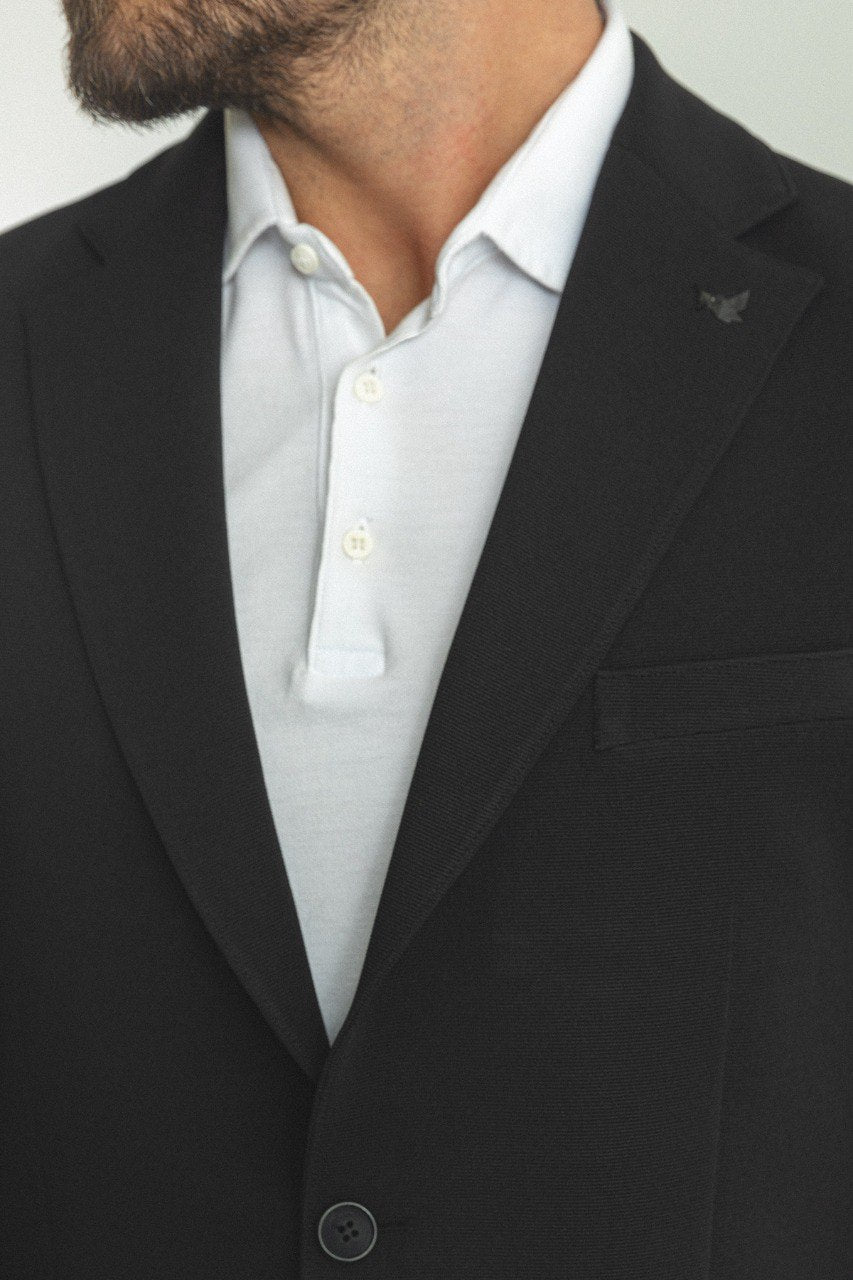 Man wearing a Noir Majesty Blazer with a pointed collar, flap pockets, and a double-button closure, perfect for weddings and formal events.