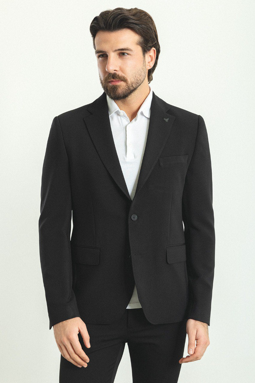 Man wearing a Noir Majesty Blazer with a pointed collar, flap pockets, and a double-button closure, perfect for weddings and formal events.