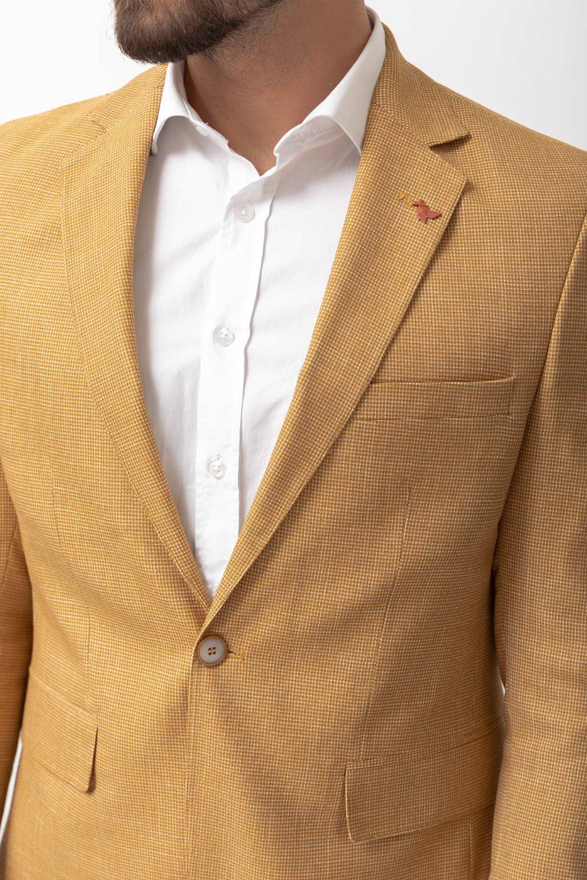 Man wearing a Sunlit Meadow Blazer with a pointed collar, flap pockets, and a slim fit, perfect for summer weddings and casual outings.