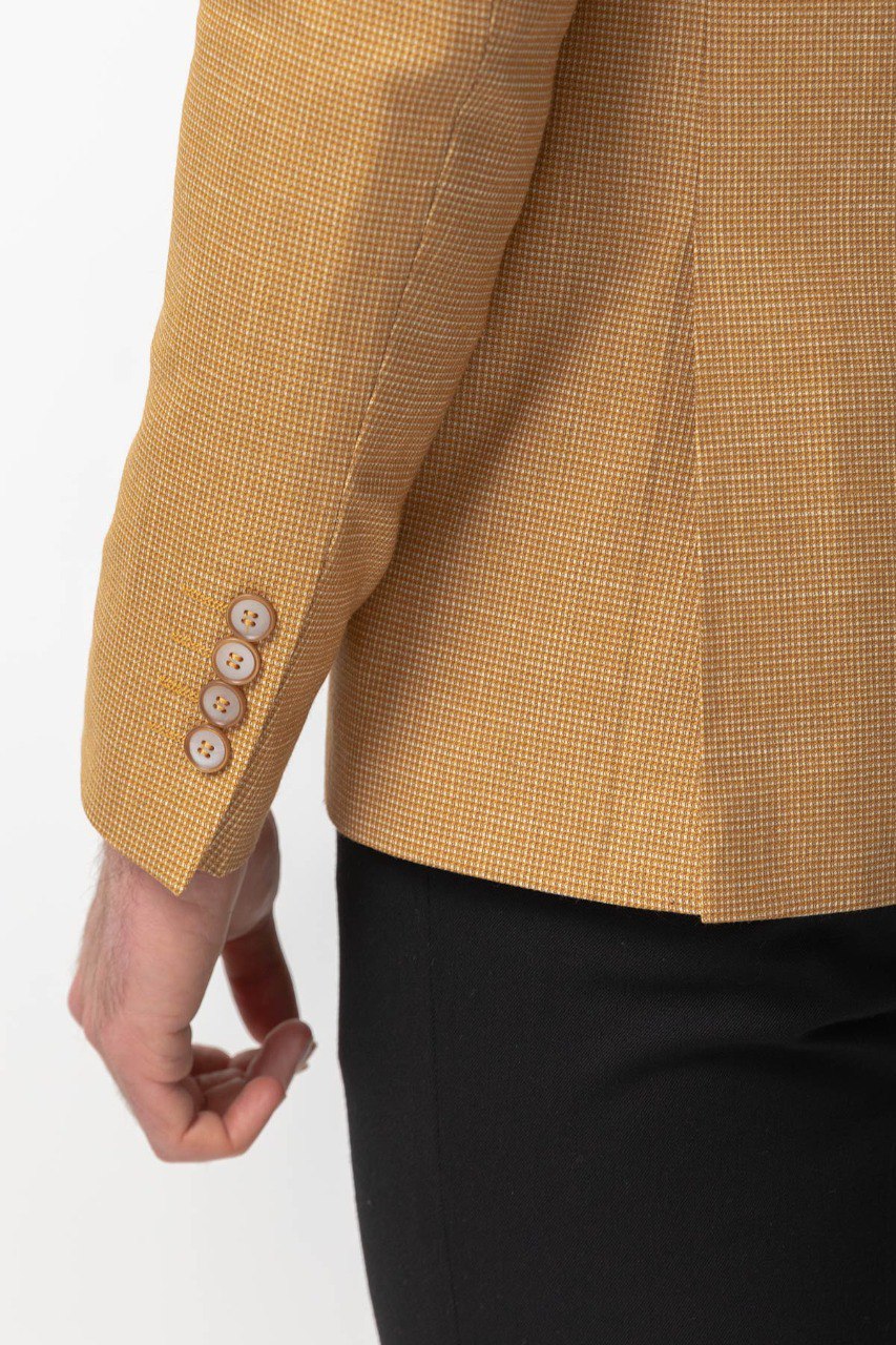 Man wearing a Sunlit Meadow Blazer with a pointed collar, flap pockets, and a slim fit, perfect for summer weddings and casual outings.