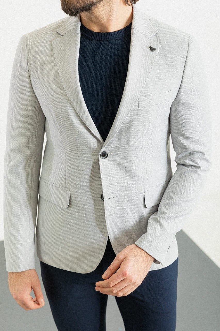 Man wearing a Silver Lining Casual Blazer with a sharp pointed collar, flap pockets, and a double-button closure, perfect for both formal and casual occasions.