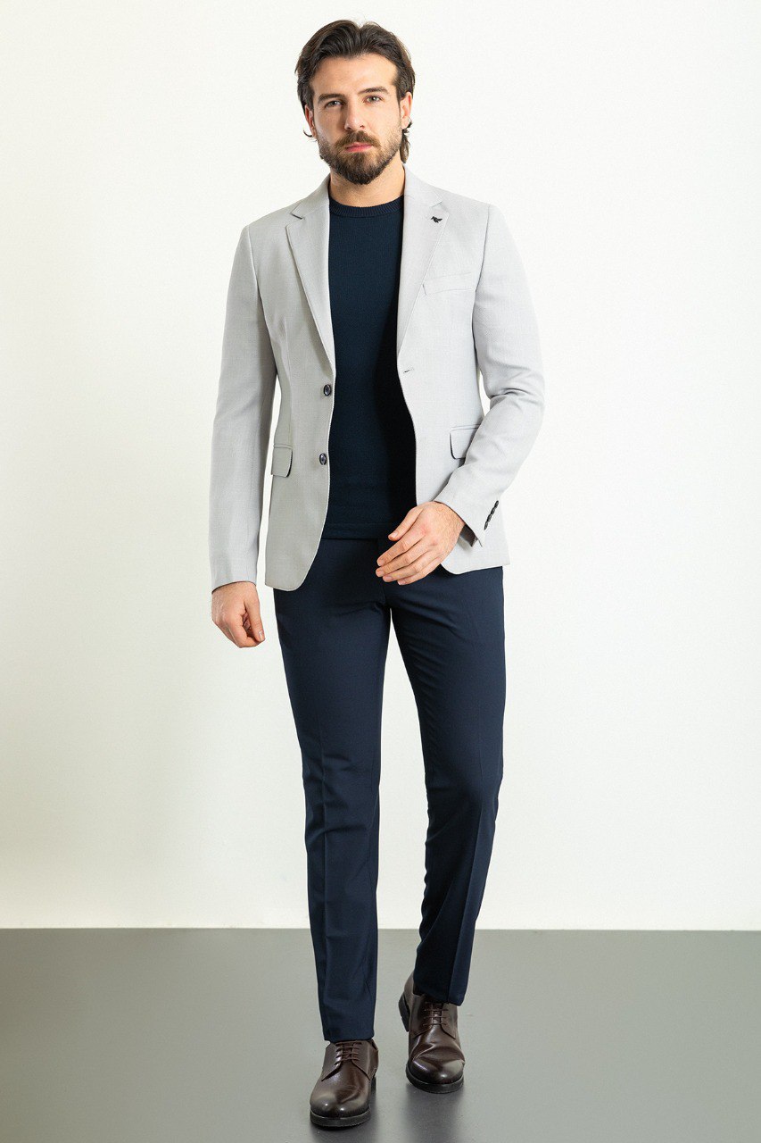 Man wearing a Silver Lining Casual Blazer with a sharp pointed collar, flap pockets, and a double-button closure, perfect for both formal and casual occasions.